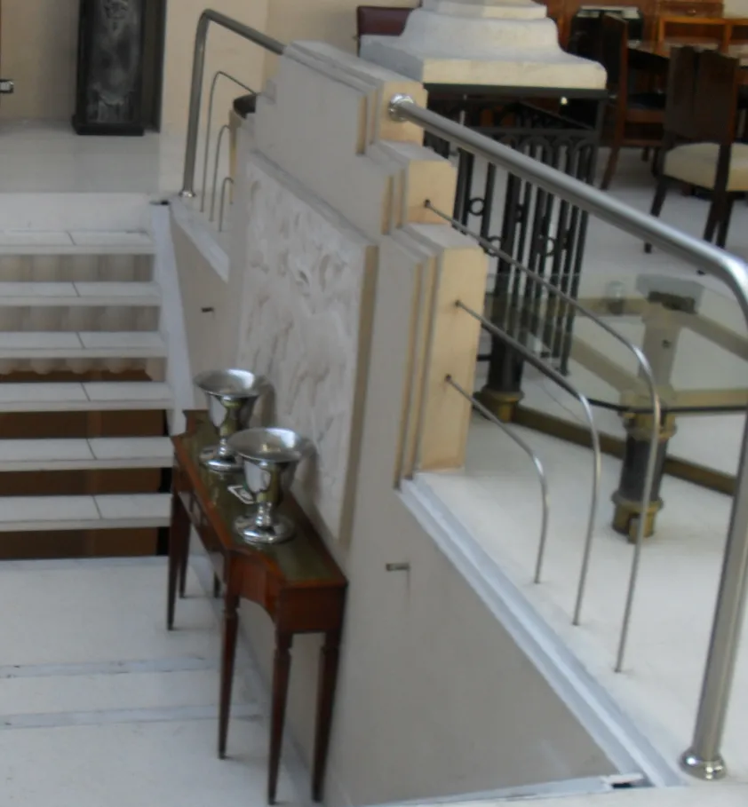 antique console table with elegant and decorative details, adorned with silver vases