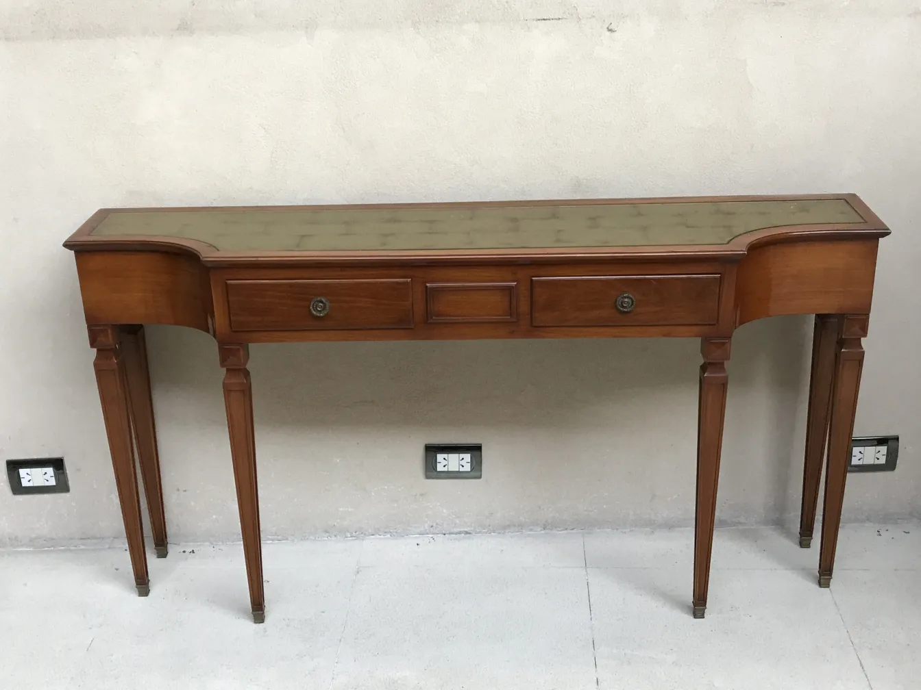antique console with decorative surface and drawers