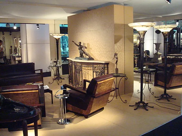 Antique console table in an elegant setting with chairs and lamps