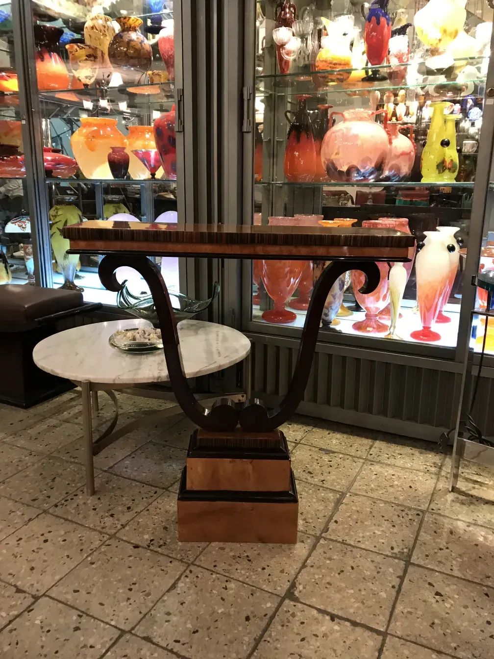 antique consoll with elegant design and shelves, decorated in a vintage setting with colorful accessories.