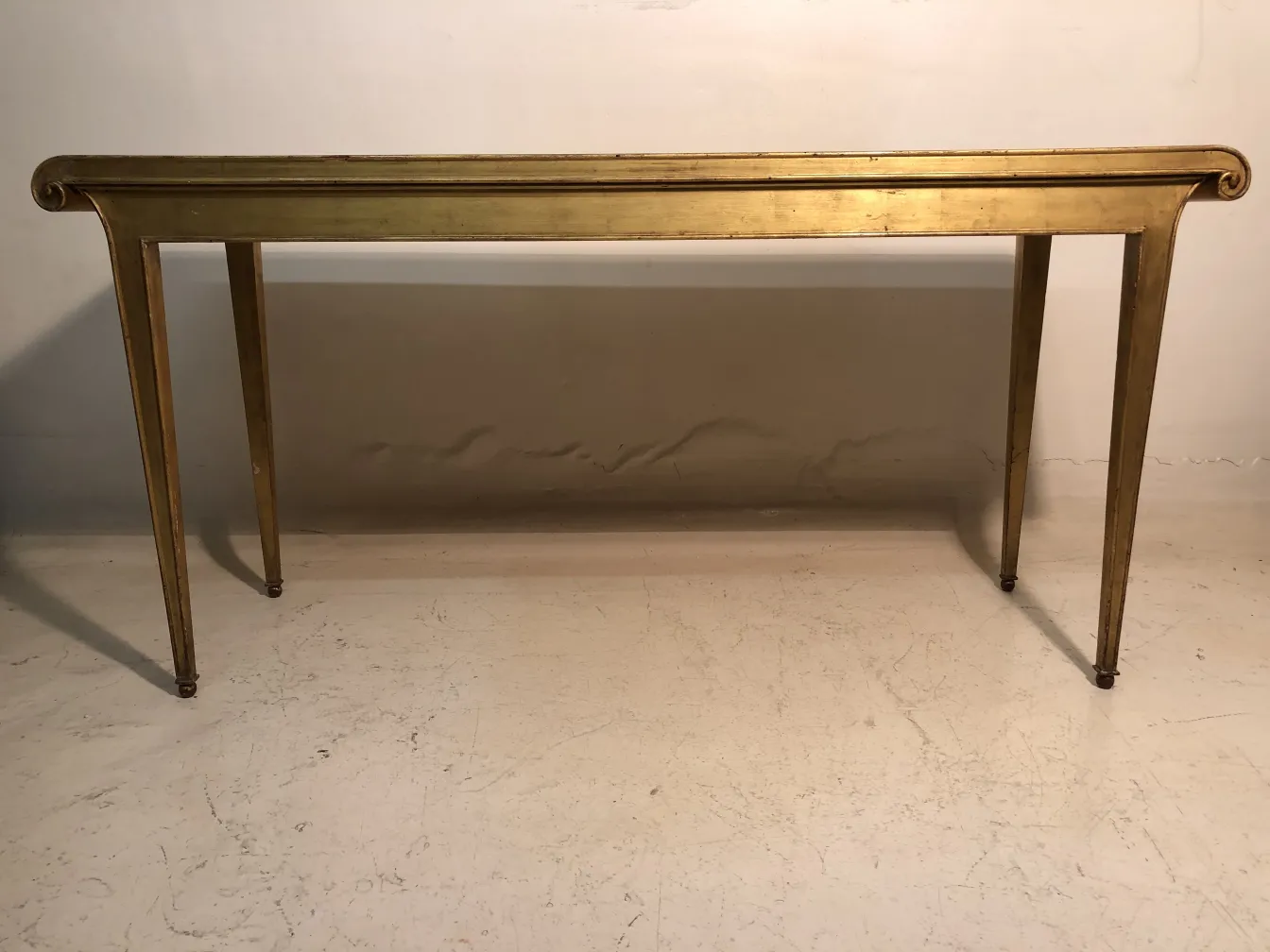 antique console with elegant legs and curved details