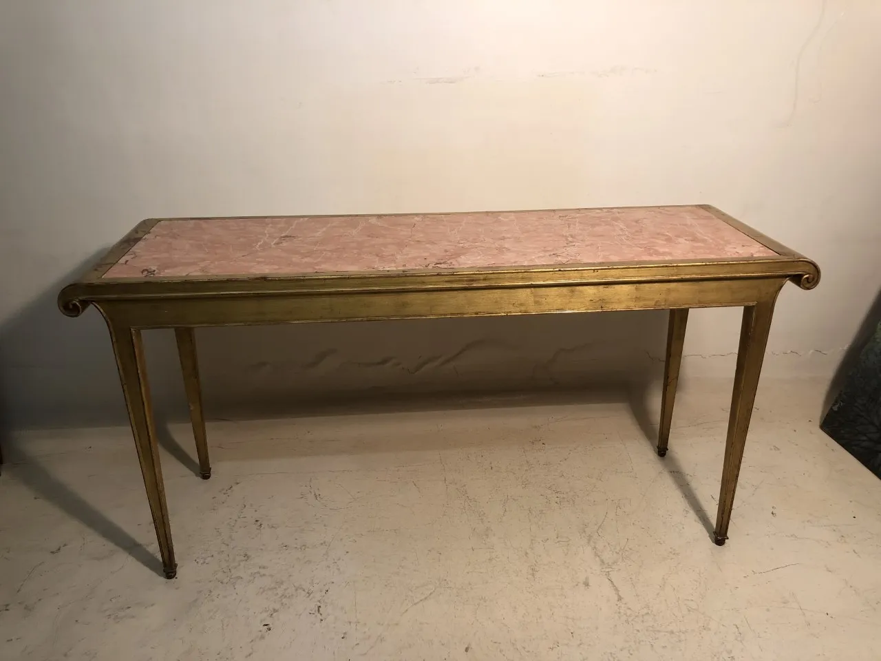antica consola con top in marmo rosa in un ambiente neutro