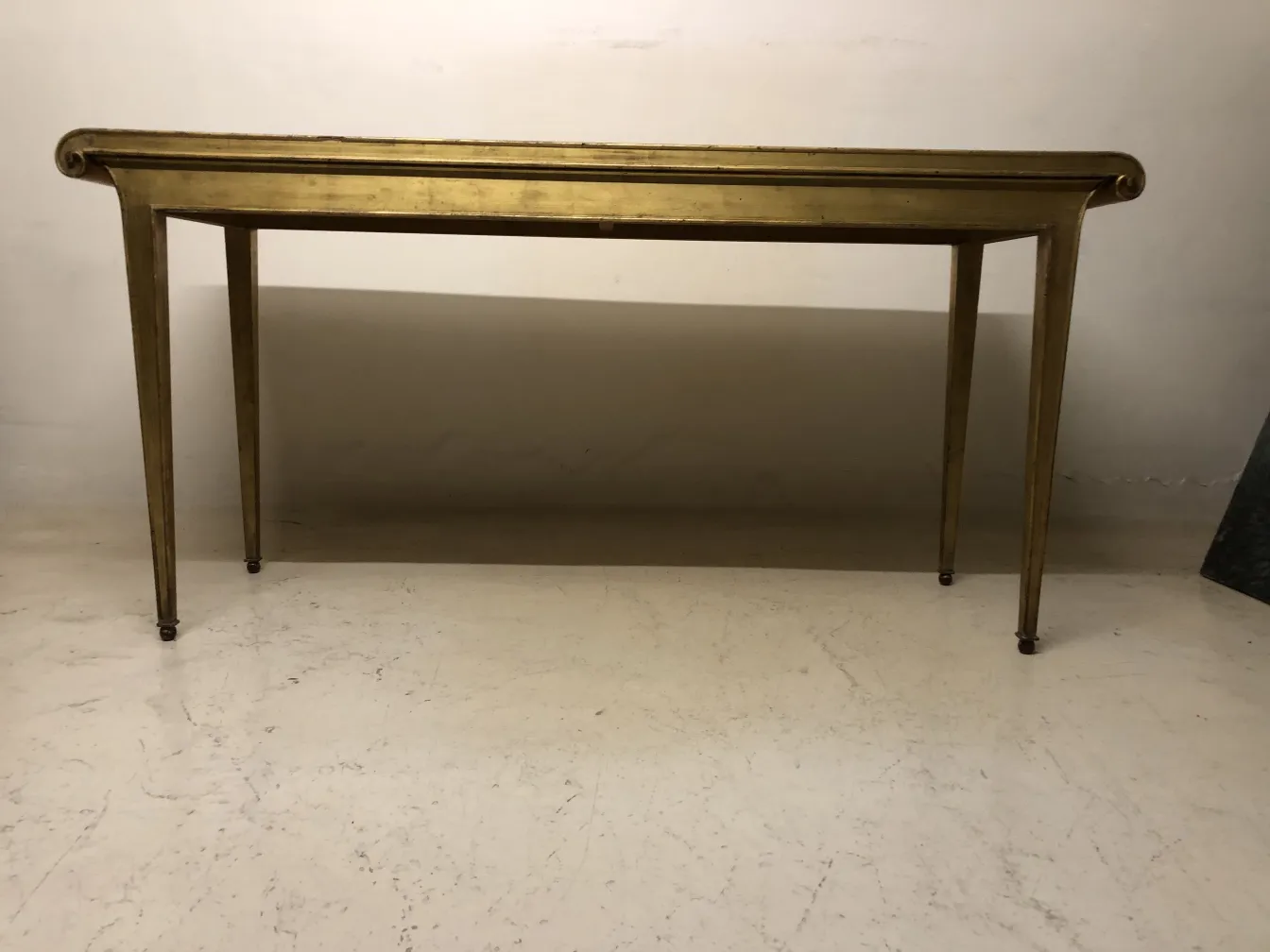 antique console with elegant legs in a neutral setting