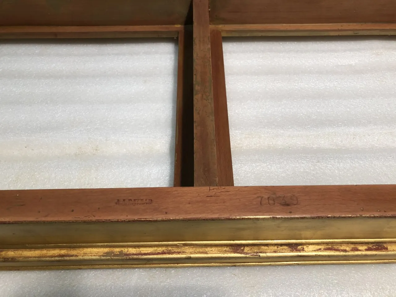 side view of an antique console with gold trim