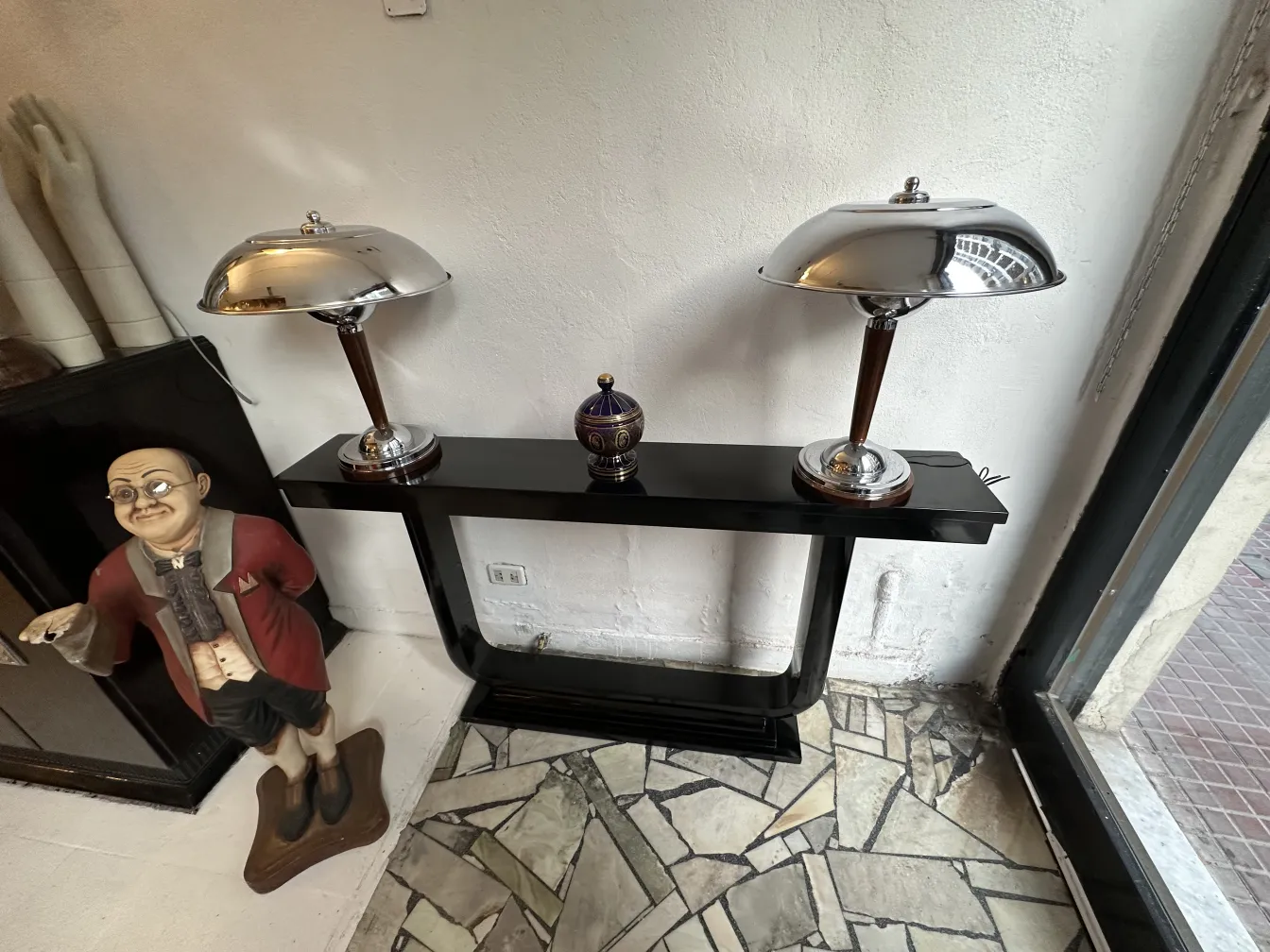 View of two antique consoles with lamps and decoration