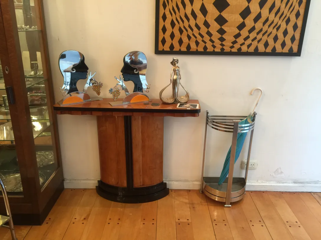 two antique consoles with mirrors and decorations