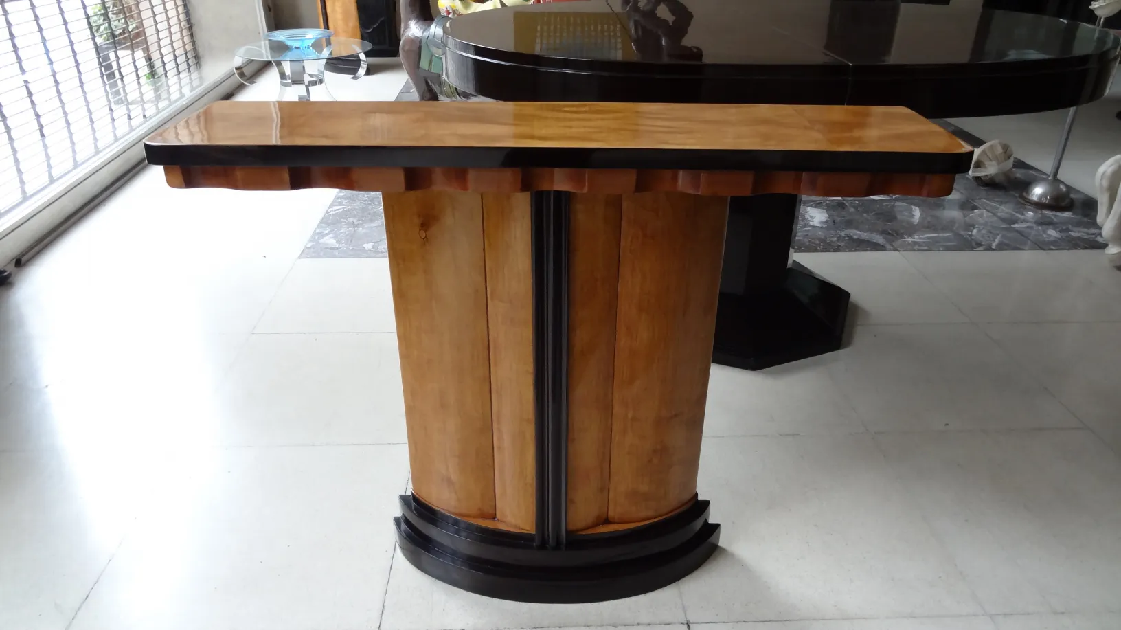 two antique consoles elegantly placed in a modern setting