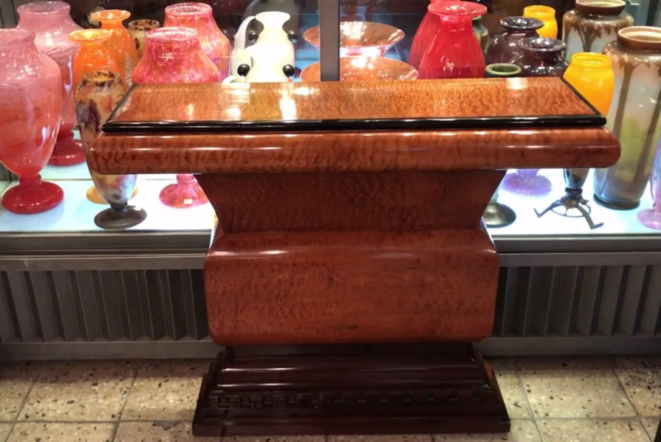antique 2 consoles with decorative vases in background