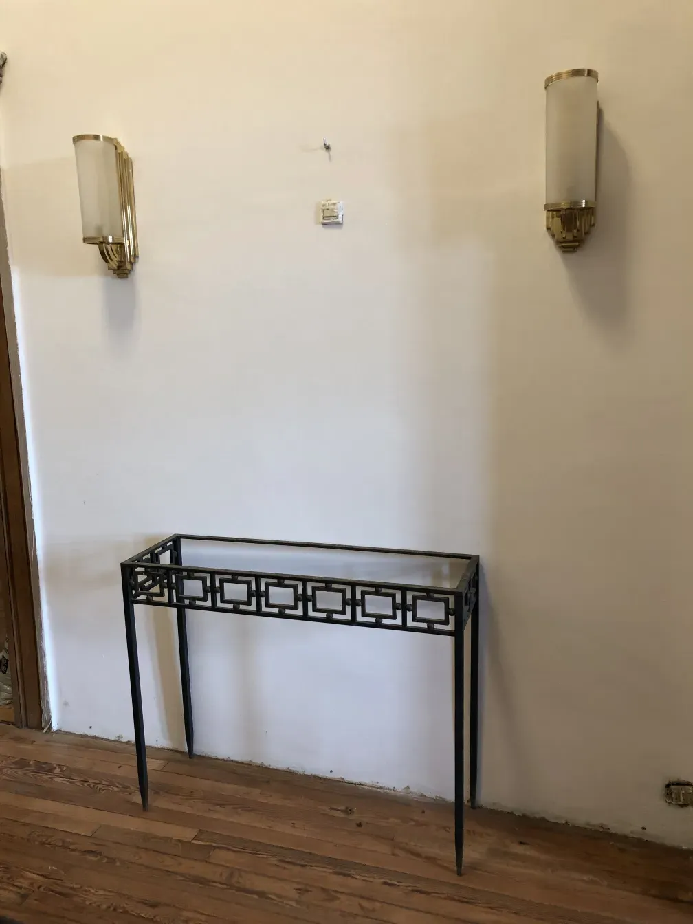 two antique consoles with decorative design in a room