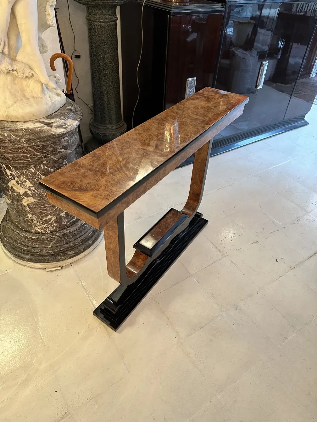 Three antique consoles from side tables in a well-lit room.