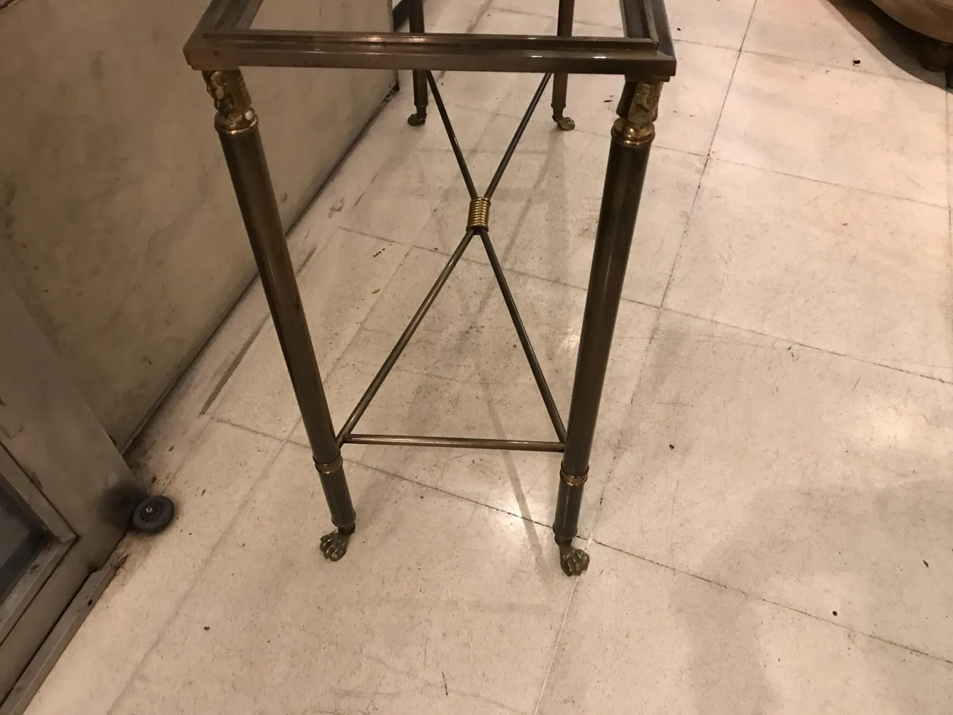 Tre consolle antiche decorative con gambe eleganti in un ambiente classico.