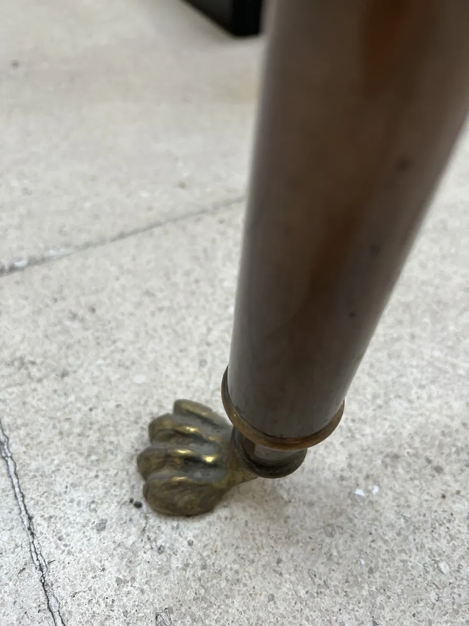 three antique consoles with lion paw feet on a concrete surface