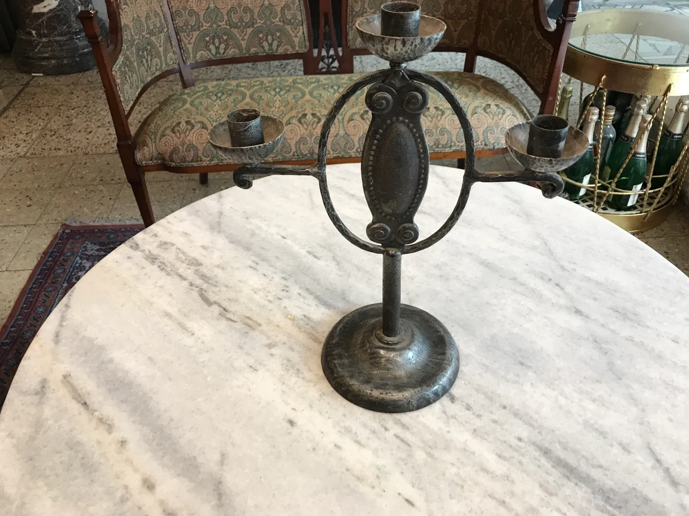 antique candelabra on marble table with decorative background