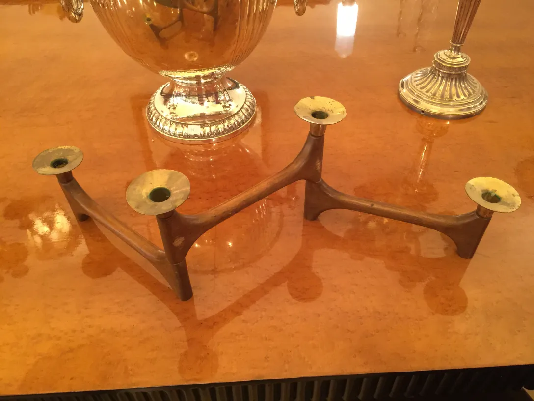 antique candelabra on a shiny table with three arm holder
