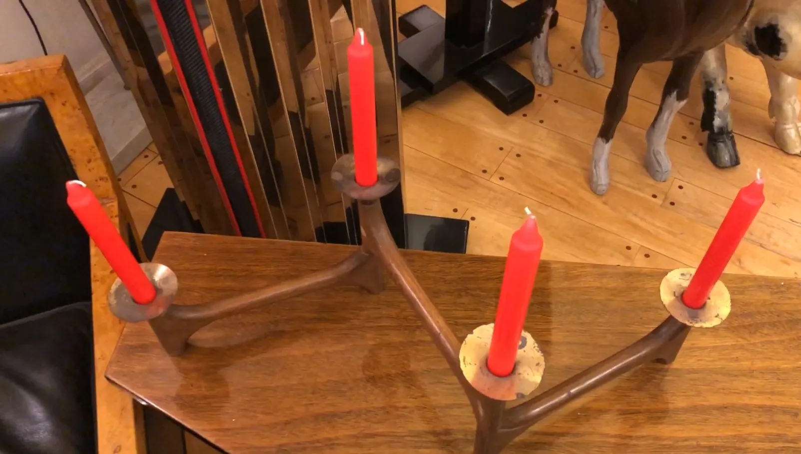 Antique candelabra with red candles on wooden table