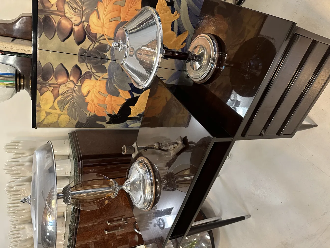 Tall antique candelabra on an elegant table with decorative items.