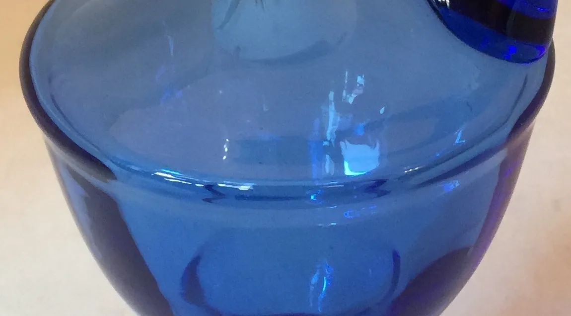 antique blue jar with a round shape and neck