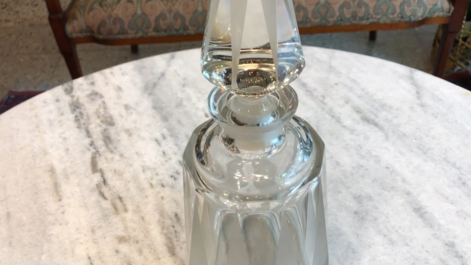 antique bottle with elegant details and lid, on marble table