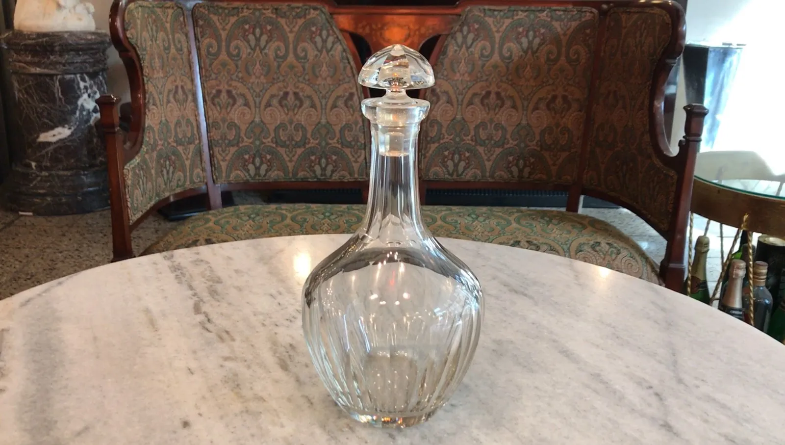 Antique bottle with elegant shape on marble table