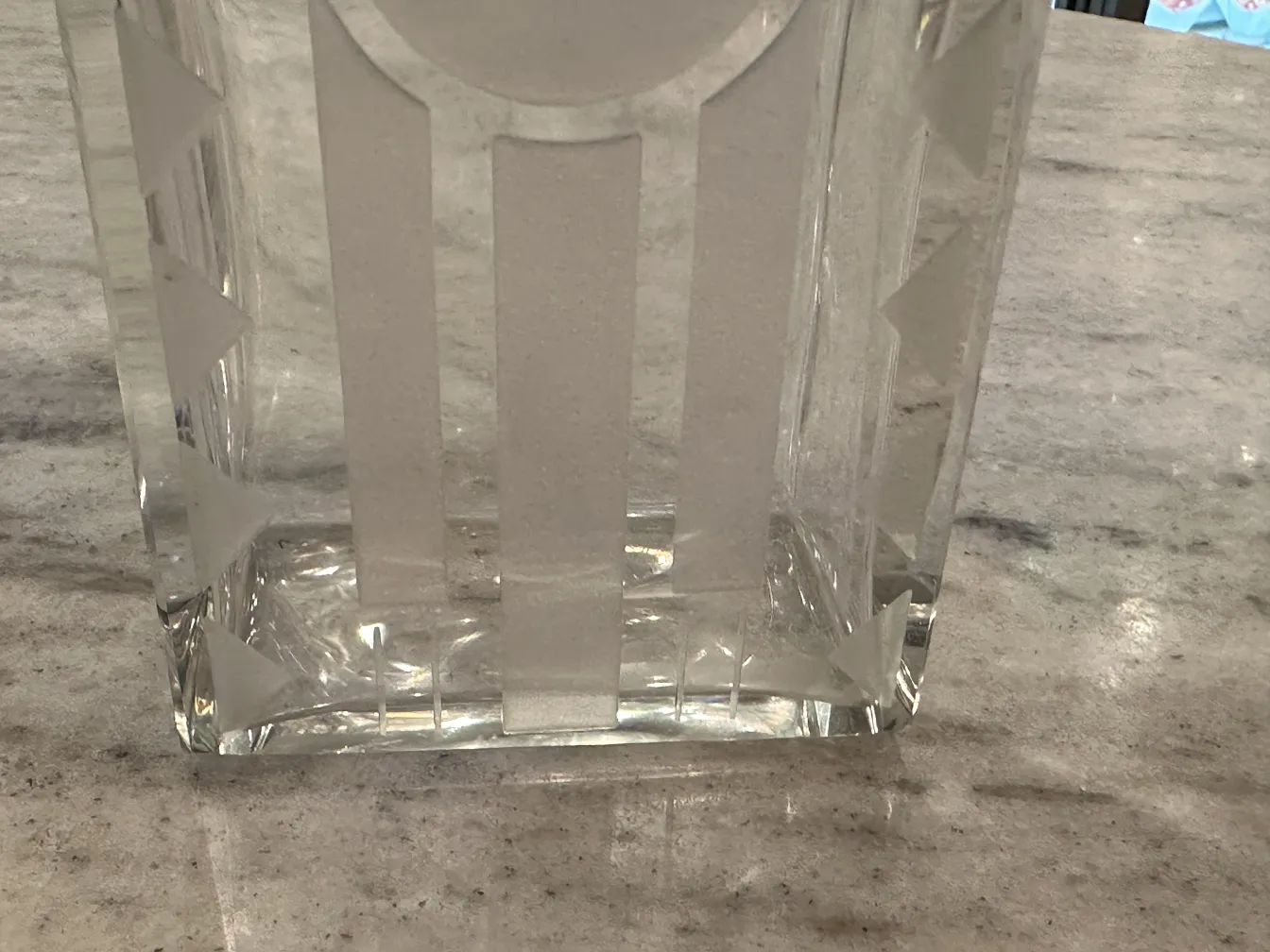 Antique bottle with visible decorations on a neutral background