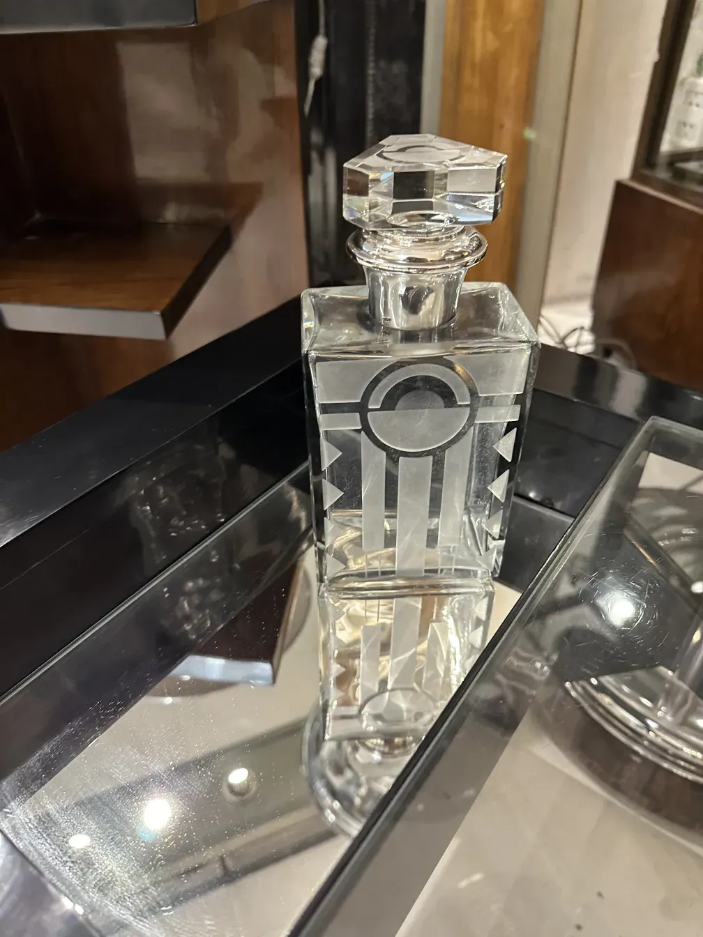 antique bottle with square lid and intricate design