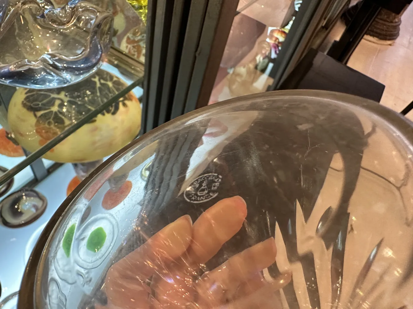 antique glass bottle in display case with decorations