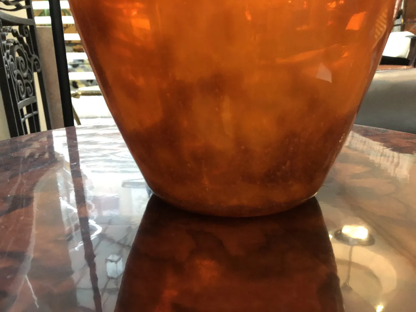 Antique glass signed Muller Fres, amber color, on table surface.