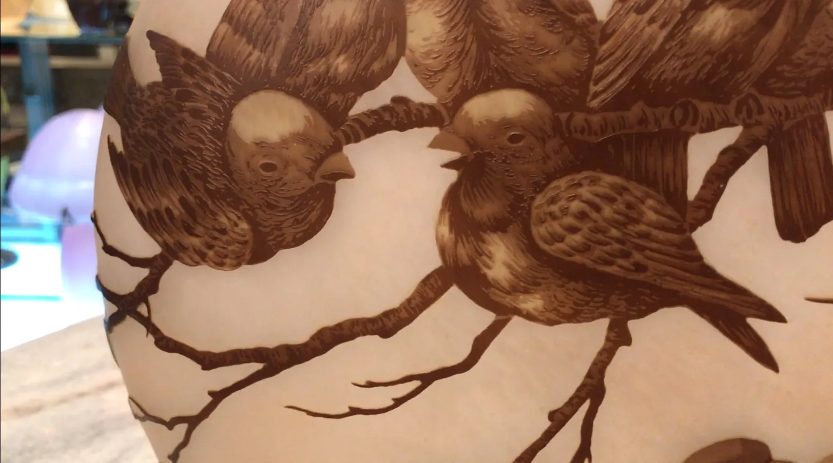 Antique signed glass by Muller Freres featuring birds etched on branches.