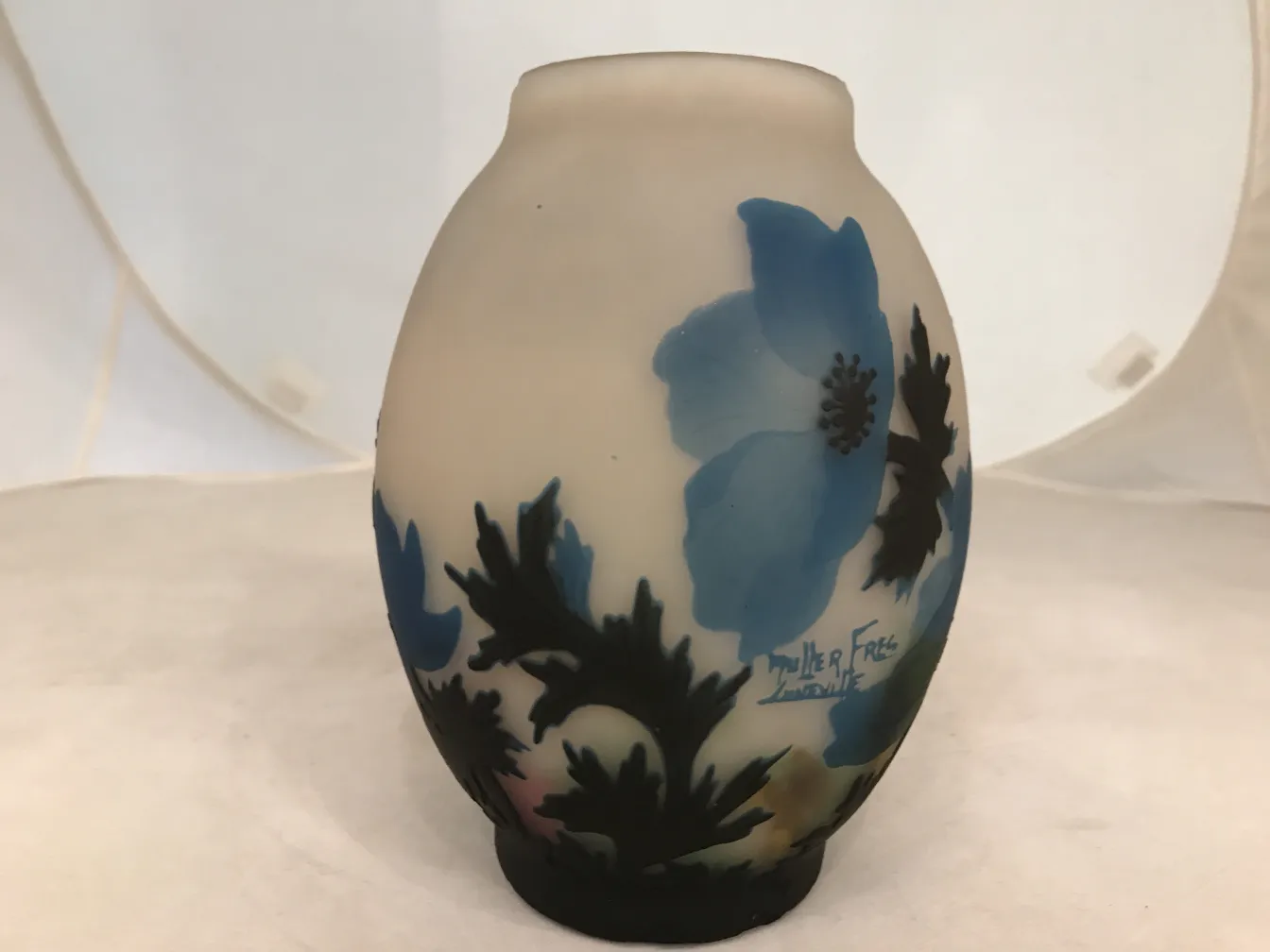 Signed glass by Muller Fres featuring blue floral design on a light background.