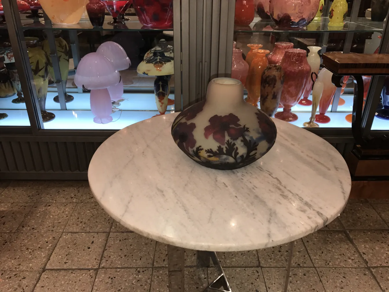 Muller fres signed glass with floral design on a marble table.