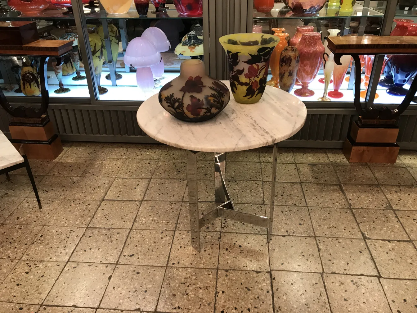 Signed Muller Fres glass with colorful details and unique shapes in an antique setting.