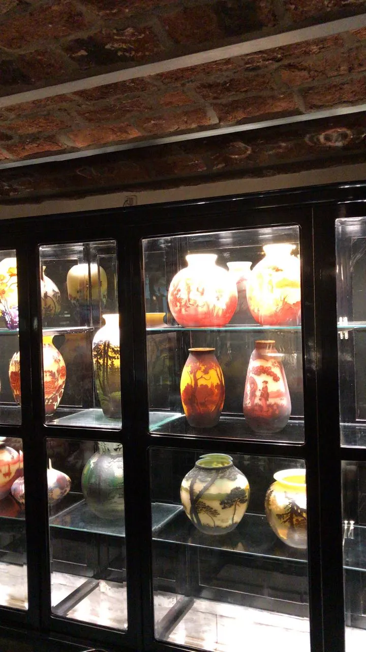 Collection of antiques featuring signed glass Muller Fres in various designs