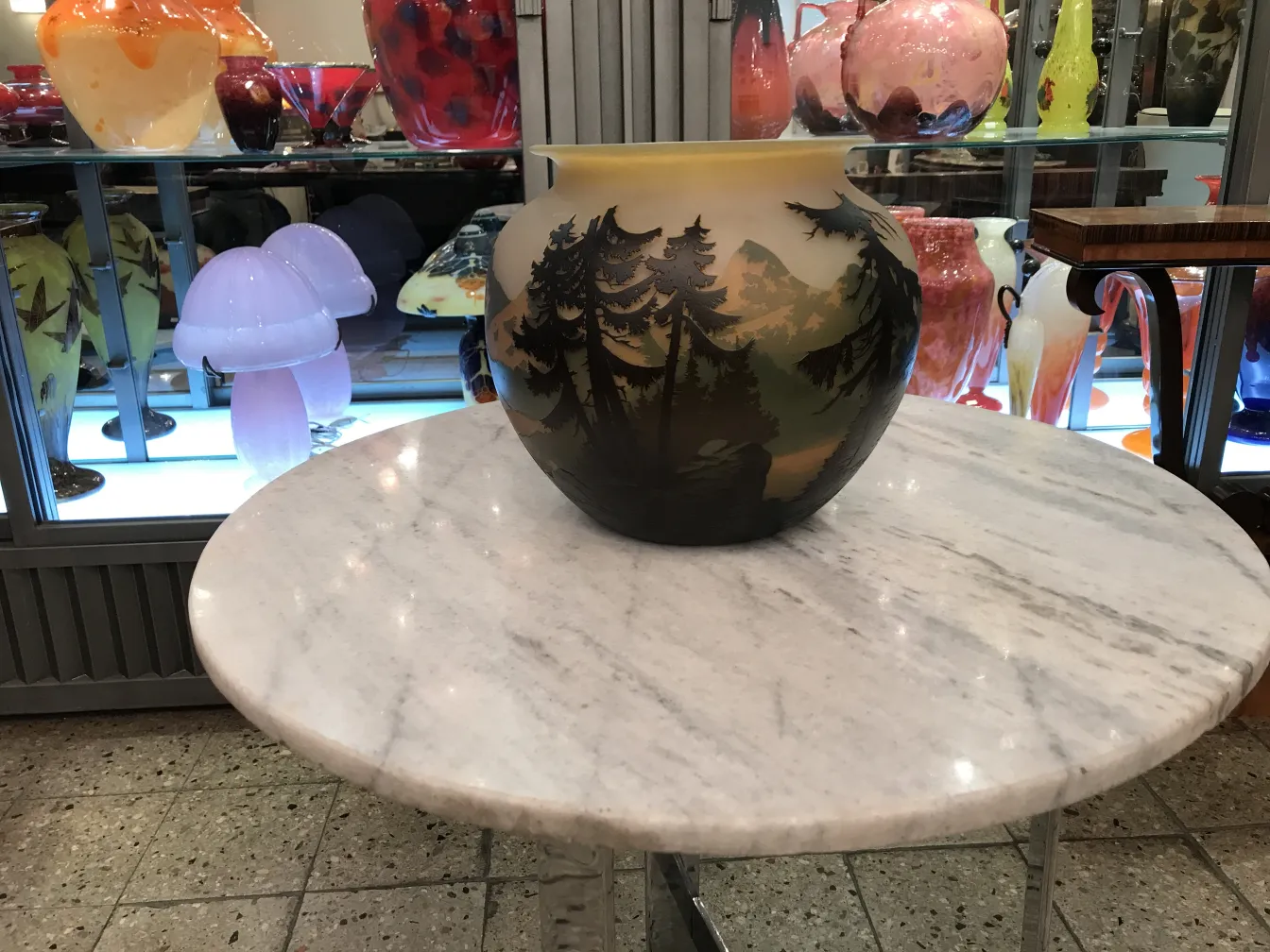 Signed glass Muller Fres in a setting with other antique objects