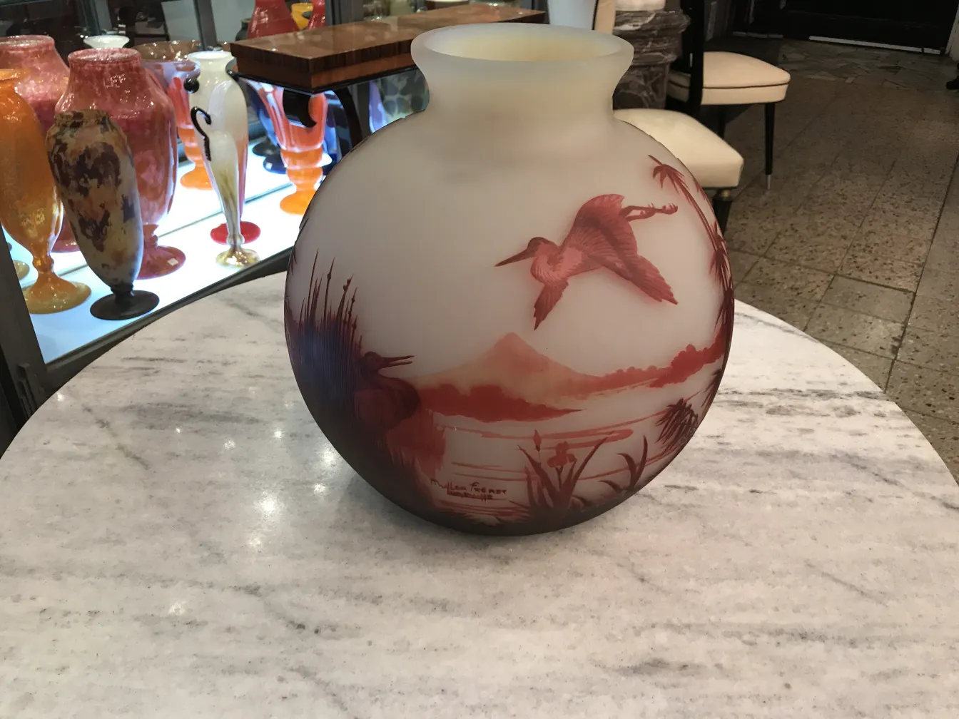 antique glass vase with bird design in natural setting