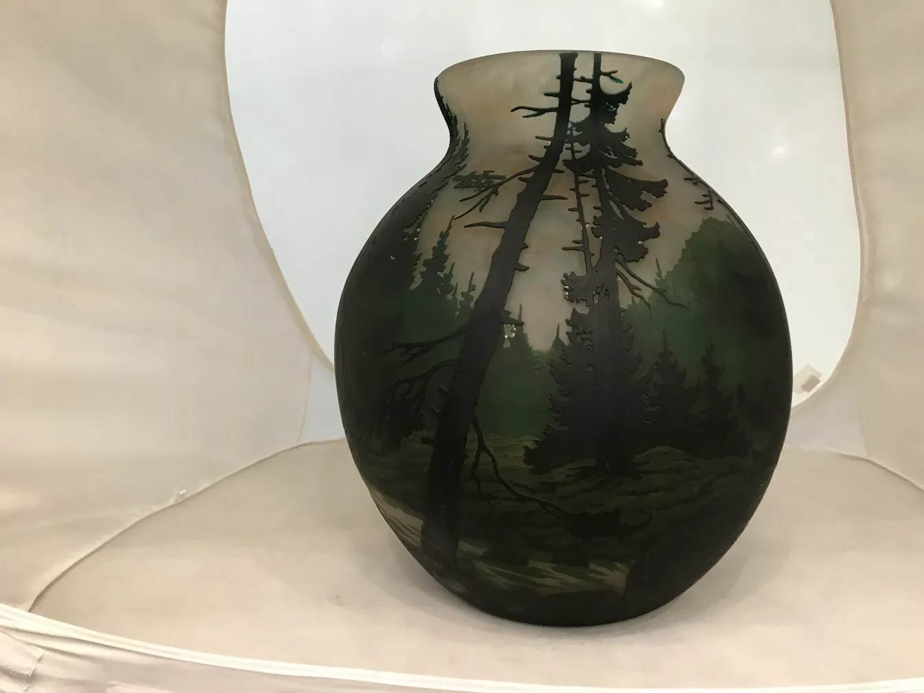 Antique jug with forest landscapes in green tones