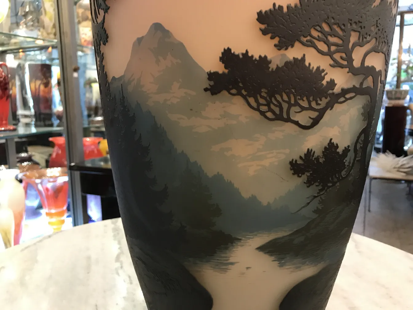 Antique glass with landscape, signed by Muller Fres, in decorative setting.