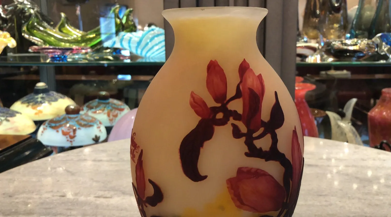 an elegant glass vase with floral design in warm colors, signed by muller fres