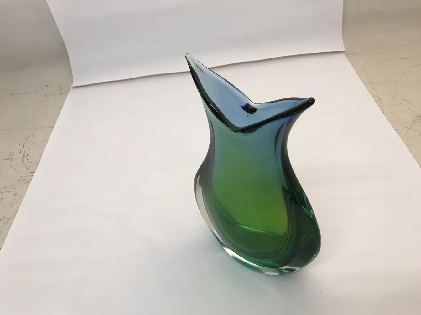 antique murano vase, green and blue colors, elegant curved shape, neutral background