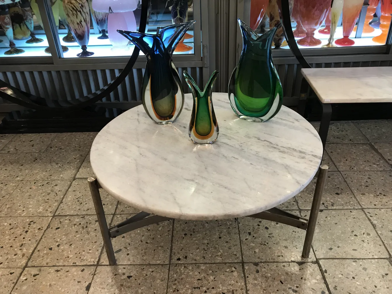 Dekorative Murano-Vasen in verschiedenen Farben auf einem Marmor Tisch.