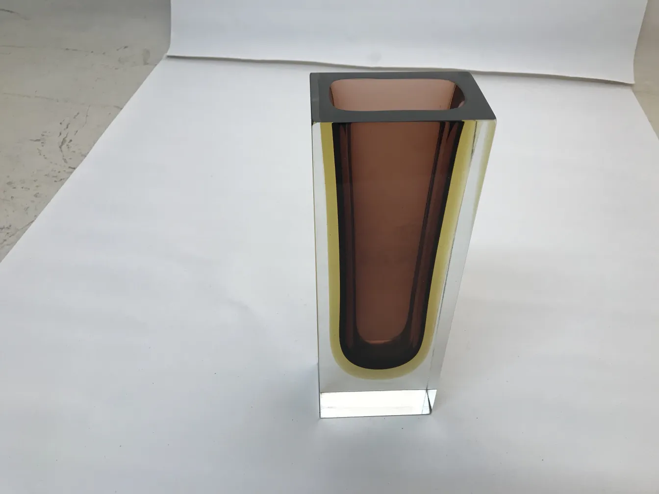 Antique Murano vase with rectangular shape and warm colors against a white background.