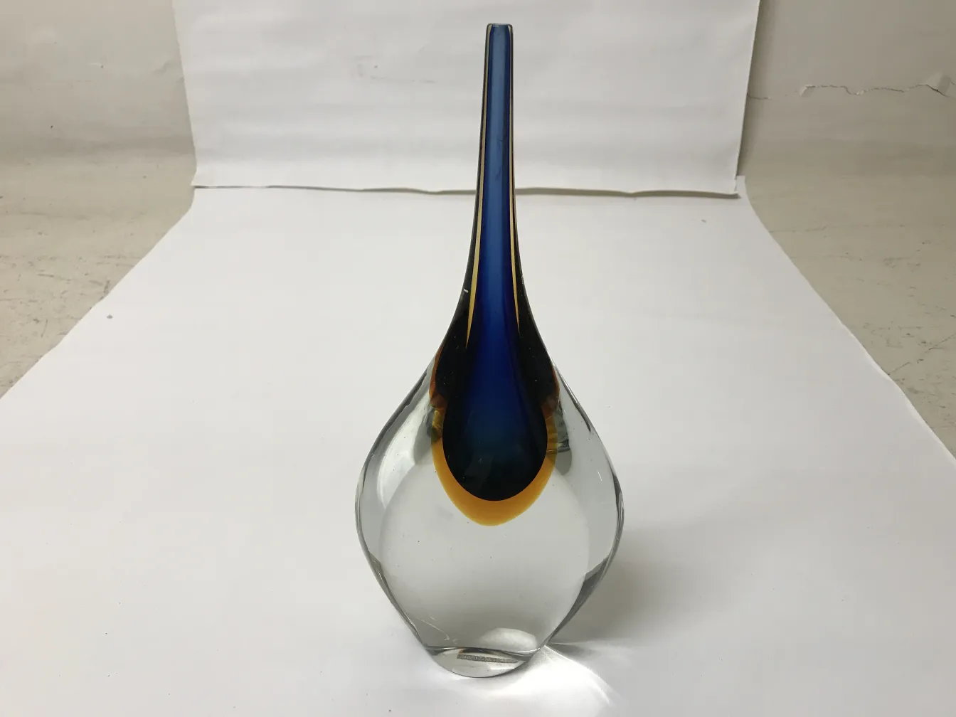 Antique Murano vase with smooth shapes and bright colors, on a white background.