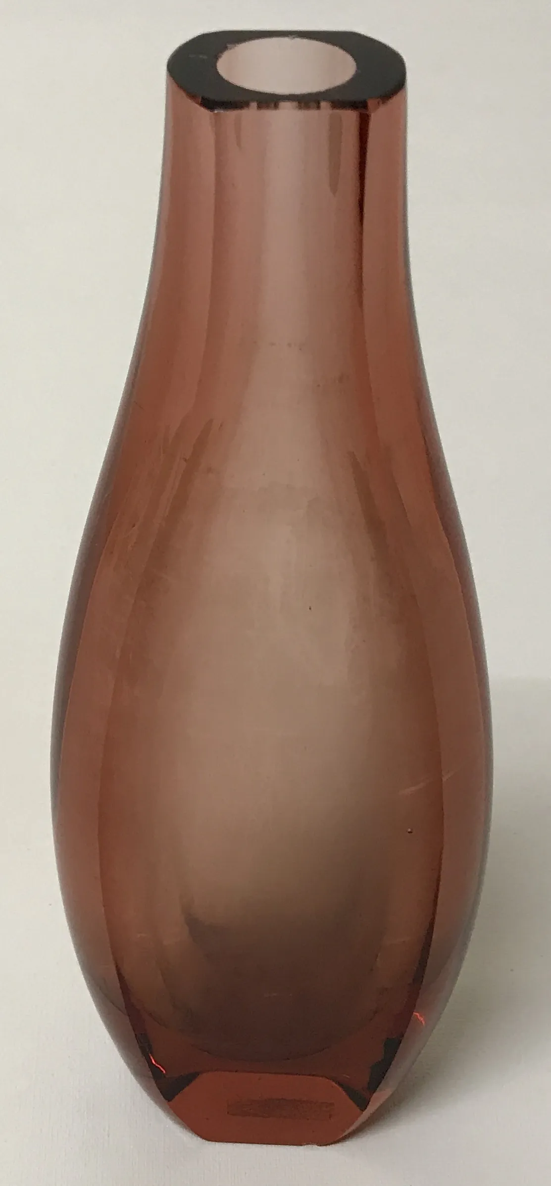 antique vase in amber color with dark rim, light background