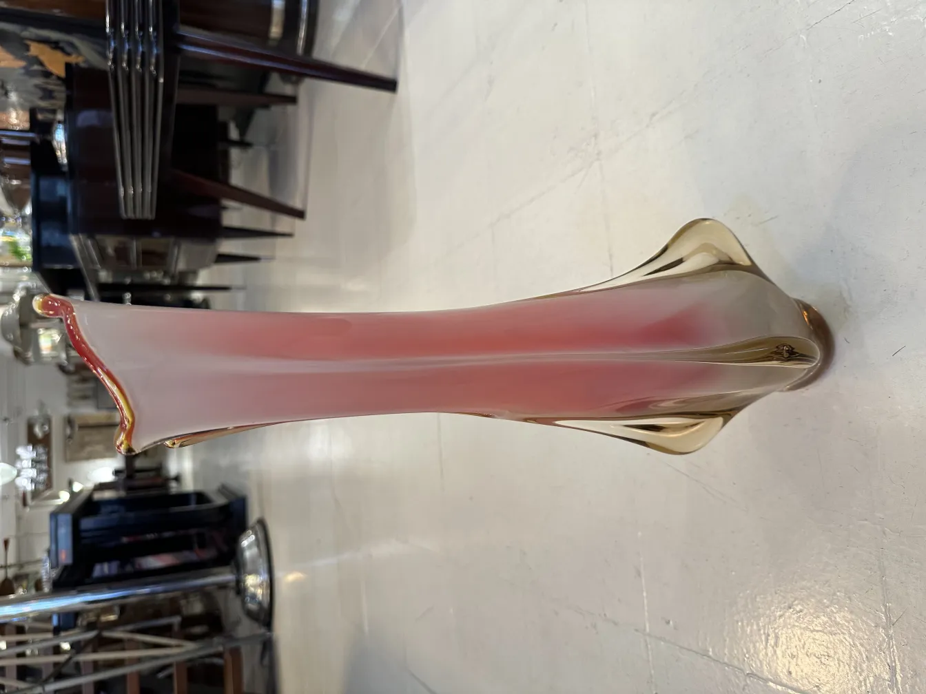 antique Murano vase with an elegant slender form, adorned in light hues, set in an antique environment