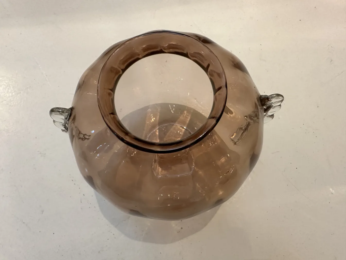 antique Murano vase in brown color with light finishes on a white surface