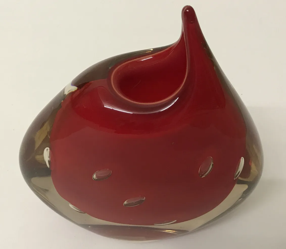 red murano vase with wavy shape and decorative holes