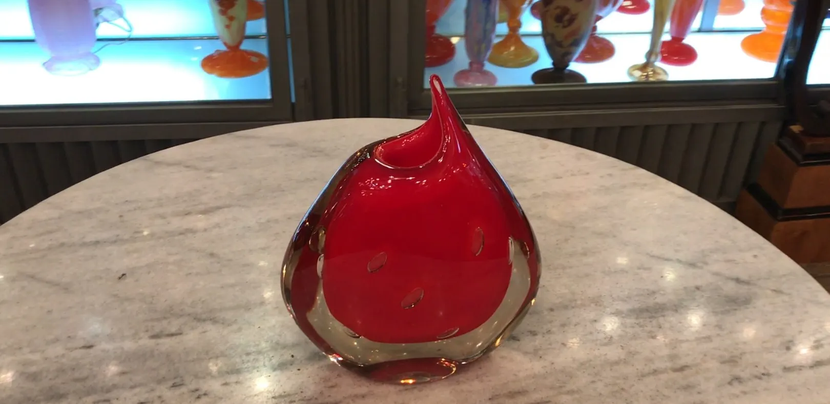 antique murano vase in red with distinctive shape on marble table
