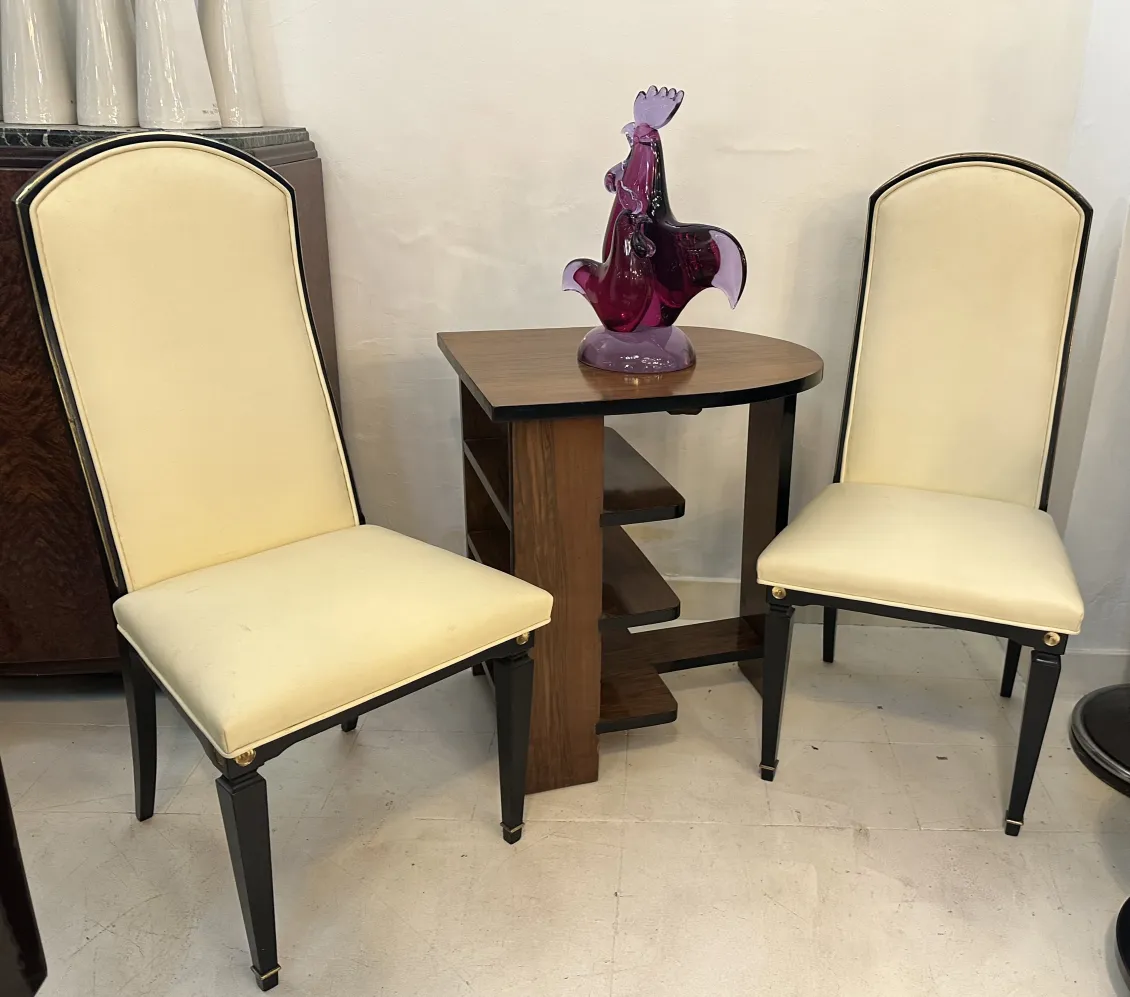 beautiful antique murano sculpture with neutral background and chairs