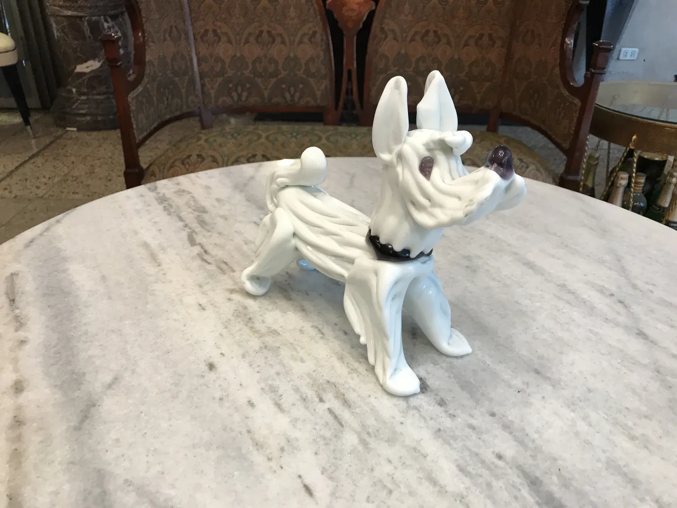antique sculpture shaped like a dog with black details