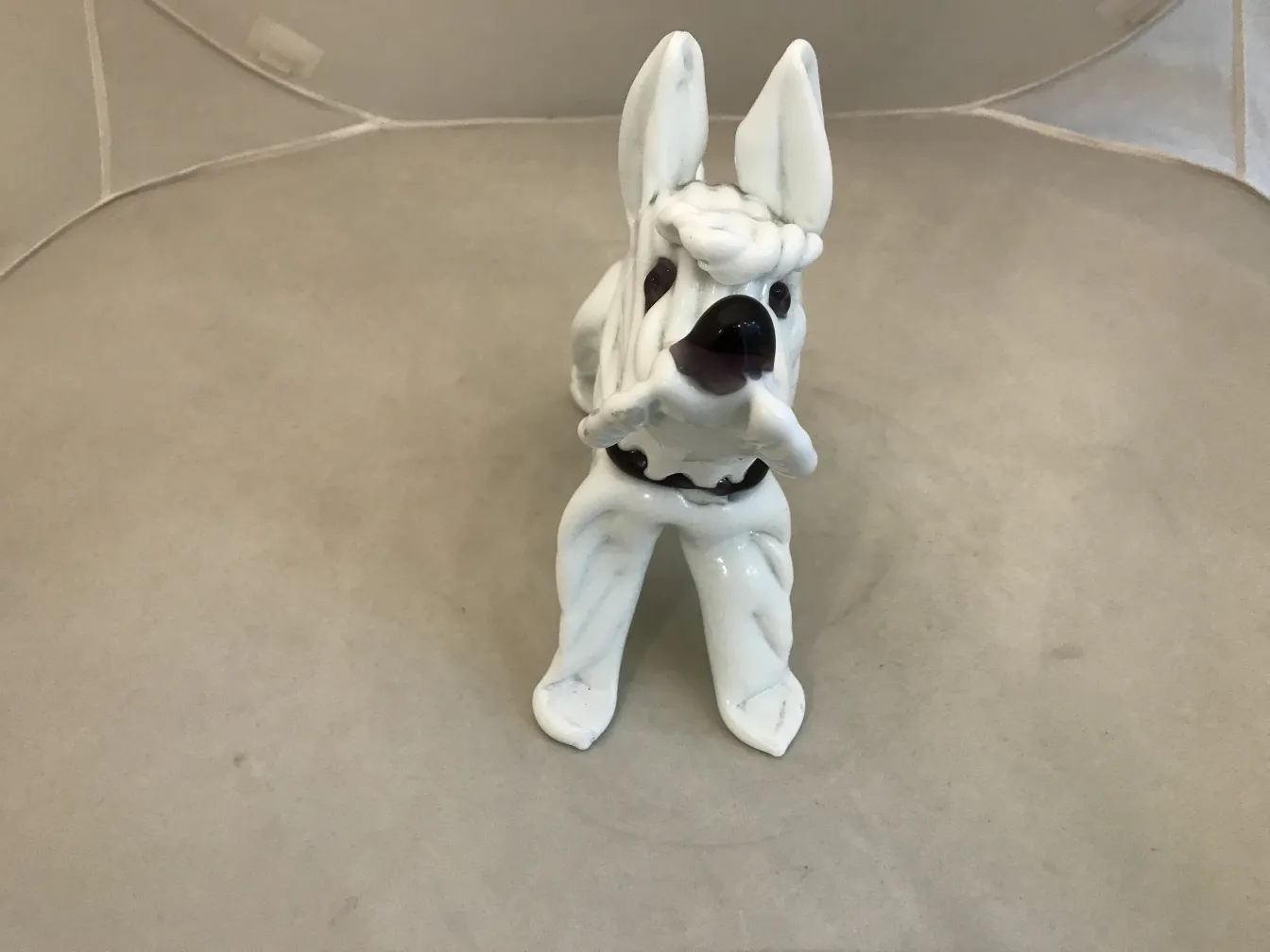 white dog sculpture with dark details, elegant design