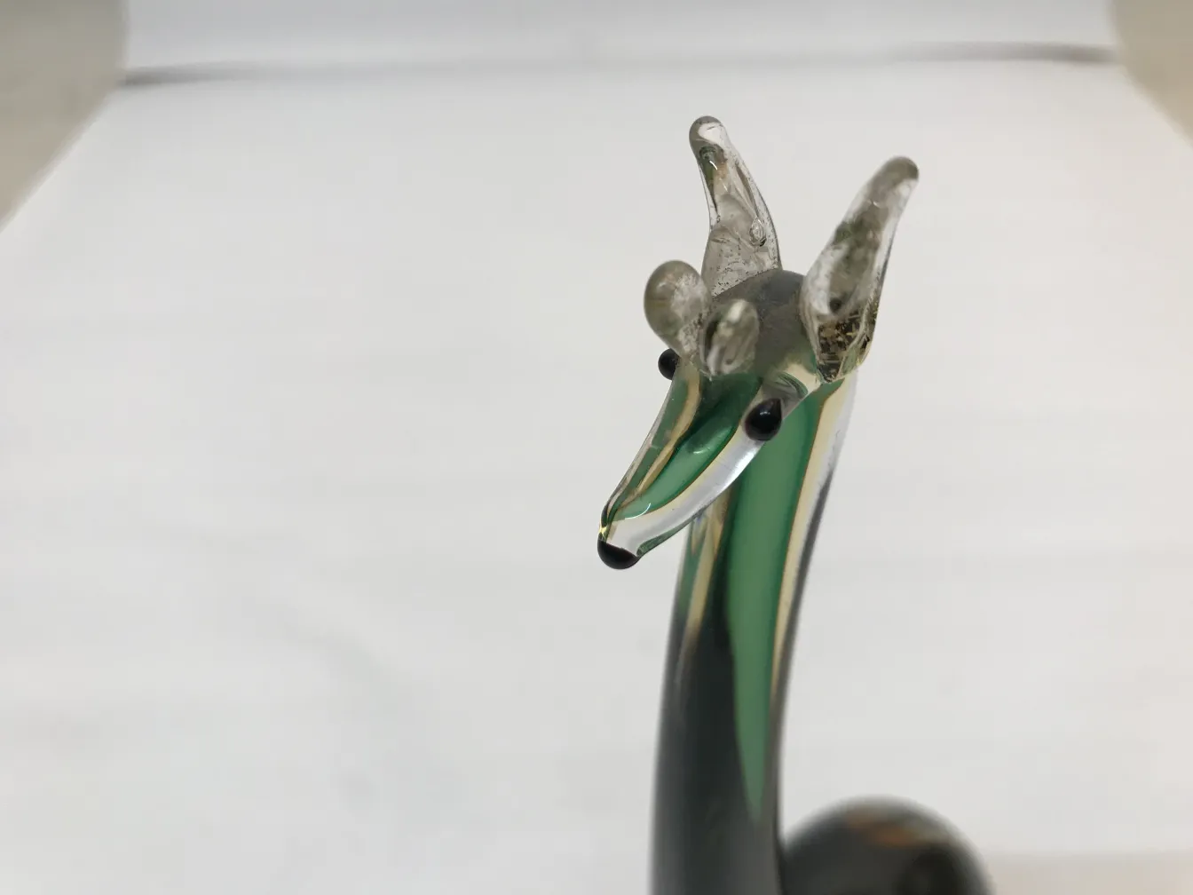 antique Murano sculpture depicting a creature with green and black details